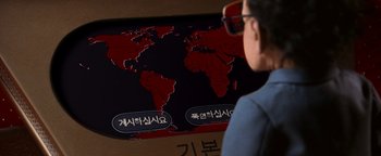 Movie still from “Team America: World Police” (2004), directed by Trey Parker – A person looking at a map of the world; Extreme Close Up shot, High angle