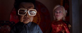 Movie still from “Team America: World Police” (2004), directed by Trey Parker – A person wearing a pair of glasses; Close Up shot, Low angle