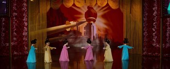 Movie still from “Team America: World Police” (2004), directed by Trey Parker – A group of little girls are dancing on a stage; Extreme Wide shot, Low angle