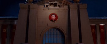 Movie still from “Team America: World Police” (2004), directed by Trey Parker – A portrait of a man is hanging on a wall; Extreme Wide shot, Low angle