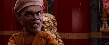 Movie still from “Team America: World Police” (2004), directed by Trey Parker – A man's face with a strange expression; Close Up shot, Low angle