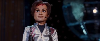 Movie still from “Team America: World Police” (2004), directed by Trey Parker – A creepy doll with blood on it's face; Close Up shot, High angle