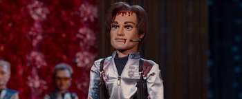 Movie still from “Team America: World Police” (2004), directed by Trey Parker – A doll of a man with blood on his face; Close Up shot, High angle