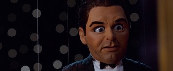 Movie still from “Team America: World Police” (2004), directed by Trey Parker – The face of a man in a tuxedo; Extreme Close Up shot, Low angle