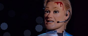 Movie still from “Team America: World Police” (2004), directed by Trey Parker – The face of a dummy with blood on it; Close Up shot, Low angle