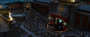 Movie still from “Team America: World Police” (2004), directed by Trey Parker – An aerial view of a theater with a lot of people watching it; Extreme Wide shot, High angle