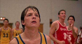 Movie still from “Teen Wolf” (1985), directed by Rod Daniel – A man with wet hair is looking upward; Close Up shot, Low angle