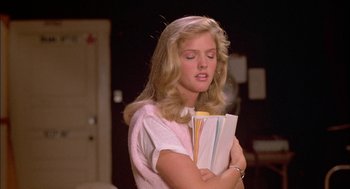 Movie still from “Teen Wolf” (1985), directed by Rod Daniel – A woman holding a bunch of papers in her hands; Close Up shot, Low angle