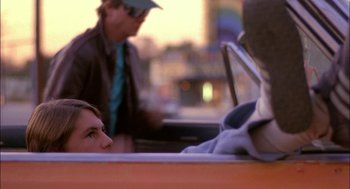 Movie still from “Teen Wolf” (1985), directed by Rod Daniel – A young boy sitting in the back of a car; Close Up shot, Over the shoulder angle