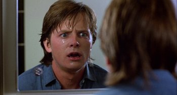 Movie still from “Teen Wolf” (1985), directed by Rod Daniel – A man crying in front of a bathroom mirror; Close Up shot, Over the shoulder angle
