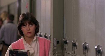 Movie still from “Teen Wolf” (1985), directed by Rod Daniel – A woman standing in front of a mirror in a room; Close Up shot, Over the shoulder angle