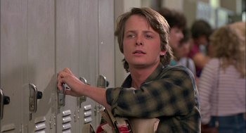 Movie still from “Teen Wolf” (1985), directed by Rod Daniel – A young man holding a key in front of a locker; Close Up shot, Low angle