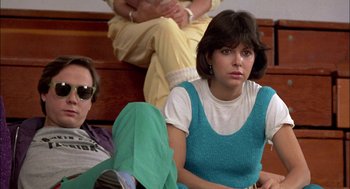 Movie still from “Teen Wolf” (1985), directed by Rod Daniel – A woman sitting next to a man on a couch; Medium shot, Low angle