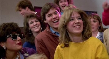 Movie still from “Teen Wolf” (1985), directed by Rod Daniel – A group of young people laughing together in a room; Close Up shot, Over the shoulder angle