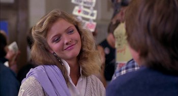 Movie still from “Teen Wolf” (1985), directed by Rod Daniel – A young woman smiles while talking to a man; Close Up shot, Over the shoulder angle