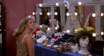 Movie still from “Teen Wolf” (1985), directed by Rod Daniel – A woman sitting in front of a vanity mirror; Medium shot, Over the shoulder angle