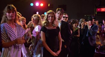 Movie still from “Teen Wolf” (1985), directed by Rod Daniel – A group of people in a crowd at a fashion show; Wide shot, Low angle