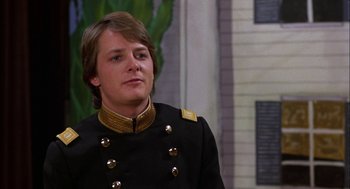 Movie still from “Teen Wolf” (1985), directed by Rod Daniel – A man in a military uniform looking to his left; Close Up shot, Over the shoulder angle