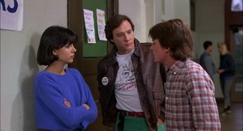 Movie still from “Teen Wolf” (1985), directed by Rod Daniel – A group of people standing next to each other in a room; Medium shot, Over the shoulder angle