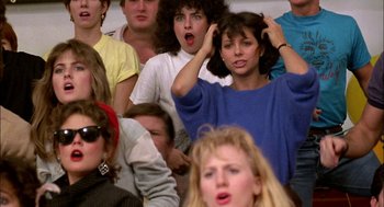 Movie still from “Teen Wolf” (1985), directed by Rod Daniel – A group of people sitting in a room; Close Up shot, High angle
