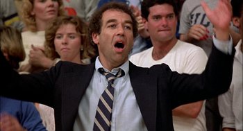 Movie still from “Teen Wolf” (1985), directed by Rod Daniel – A man in a black suit and a striped tie; Close Up shot, Low angle