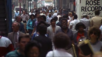 Movie still from “Teenage Mutant Ninja Turtles” (1990), directed by Steve Barron – A crowd of people walking down a street; Extreme Wide shot, High angle
