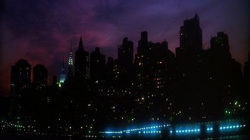 Movie still from “Teenage Mutant Ninja Turtles” (1990), directed by Steve Barron – A view of a city skyline at night with lights on; Extreme Wide shot, Low angle