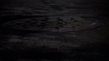 Movie still from “Teenage Mutant Ninja Turtles” (1990), directed by Steve Barron – View of a manhole cover in the dark; Extreme Close Up shot, Overhead angle