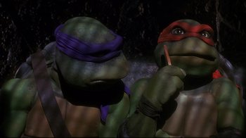 Movie still from “Teenage Mutant Ninja Turtles” (1990), directed by Steve Barron – A teenage mutant ninja turtle holding a pencil; Close Up shot, Low angle