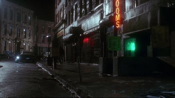 Movie still from “Teenage Mutant Ninja Turtles” (1990), directed by Steve Barron – A city street at night lit by street lights; Wide shot, High angle