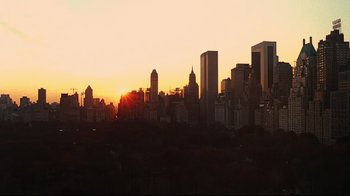 Movie still from “Teenage Mutant Ninja Turtles” (1990), directed by Steve Barron – The sun is setting over a city skyline; Extreme Wide shot, High angle