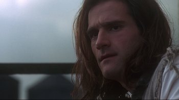 Movie still from “Teenage Mutant Ninja Turtles” (1990), directed by Steve Barron – A person with long brown hair; Close Up shot, Low angle