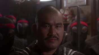 Movie still from “Teenage Mutant Ninja Turtles” (1990), directed by Steve Barron – A person with a mustache; Close Up shot, Low angle