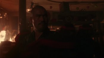 Movie still from “Teenage Mutant Ninja Turtles” (1990), directed by Steve Barron – A man with a goatee is looking at the camera; Close Up shot, Low angle