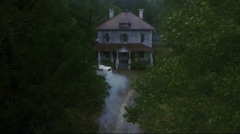 Movie still from “Teenage Mutant Ninja Turtles” (1990), directed by Steve Barron – An aerial view of a house with a car parked in front of it; Extreme Wide shot, High angle