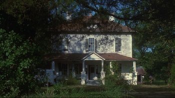 Movie still from “Teenage Mutant Ninja Turtles” (1990), directed by Steve Barron – An old white house sitting in the middle of a forest; Extreme Wide shot, Low angle