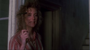 Movie still from “Teenage Mutant Ninja Turtles” (1990), directed by Steve Barron – A woman holding a pair of scissors in her hand; Close Up shot, Over the shoulder angle