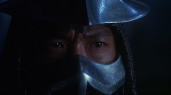 Movie still from “Teenage Mutant Ninja Turtles” (1990), directed by Steve Barron – A person wearing a metal mask; Close Up shot, High angle