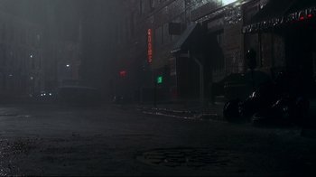 Movie still from “Teenage Mutant Ninja Turtles” (1990), directed by Steve Barron – A street scene with a street sign and a building; Extreme Wide shot, High angle
