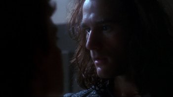 Movie still from “Teenage Mutant Ninja Turtles” (1990), directed by Steve Barron – A person with long curly hair; Close Up shot, Over the shoulder angle