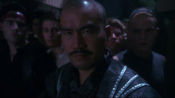 Movie still from “Teenage Mutant Ninja Turtles” (1990), directed by Steve Barron – A person wearing a black shirt; Close Up shot, Low angle