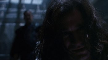 Movie still from “Teenage Mutant Ninja Turtles” (1990), directed by Steve Barron – A man with long hair is looking at the camera; Close Up shot, Over the shoulder angle