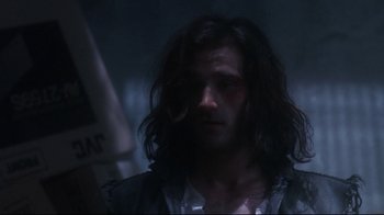 Movie still from “Teenage Mutant Ninja Turtles” (1990), directed by Steve Barron – A person with long black hair; Close Up shot, Low angle