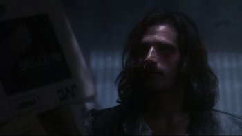 Movie still from “Teenage Mutant Ninja Turtles” (1990), directed by Steve Barron – A person with long dark hair; Close Up shot, Over the shoulder angle