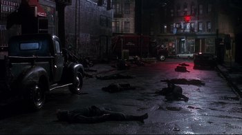 Movie still from “Teenage Mutant Ninja Turtles” (1990), directed by Steve Barron – A group of dead bodies laying on the ground in the dark; Extreme Wide shot, High angle
