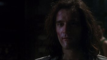 Movie still from “Teenage Mutant Ninja Turtles” (1990), directed by Steve Barron – A person with long dark hair; Close Up shot, Low angle