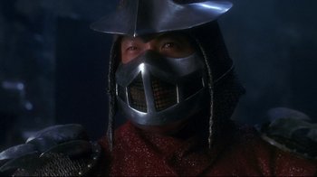 Movie still from “Teenage Mutant Ninja Turtles” (1990), directed by Steve Barron – A man wearing a metal helmet and holding a sword; Close Up shot, Low angle