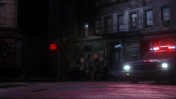 Movie still from “Teenage Mutant Ninja Turtles” (1990), directed by Steve Barron – A group of people standing on the side of the street; Wide shot, Low angle
