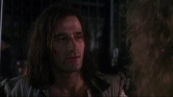 Movie still from “Teenage Mutant Ninja Turtles” (1990), directed by Steve Barron – A person with long brown hair; Close Up shot, Over the shoulder angle