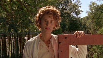 Movie still from “Temple Grandin” (2010), directed by Mick Jackson – A young man with curly red hair holding a wooden fence post; Close Up shot, Low angle